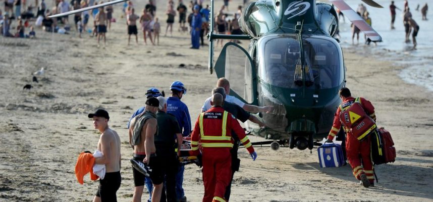 Weymouth beach, Dorset, UK. 30th Jun, 2018. An injured man is stretchered onto an air ambulance after an incident on Weymouth beach Credit: Finnbarr Webster/Alamy Live News
