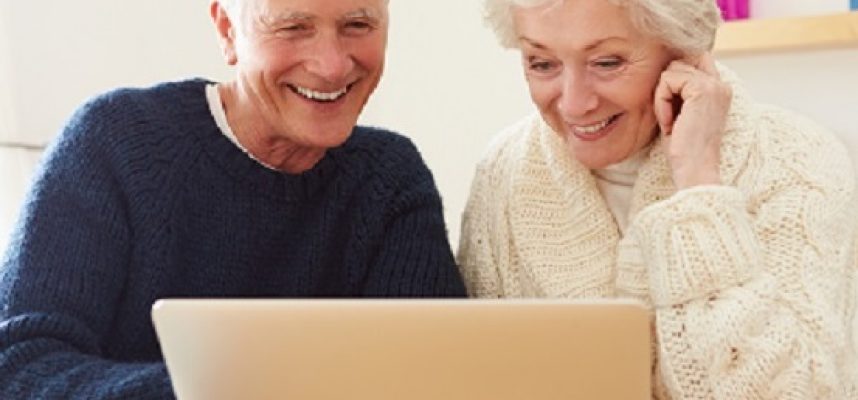senior couple with coffee at the laptop- website