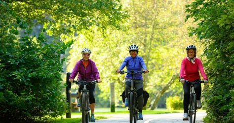 Active seniors cycling on a paved trail