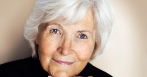 Portrait of senior lady with grey hair and blue eyes